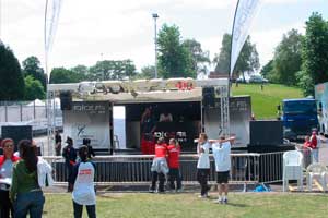 outside stage in park with dj and people watching