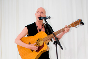 Richard O'Brian playing guitar